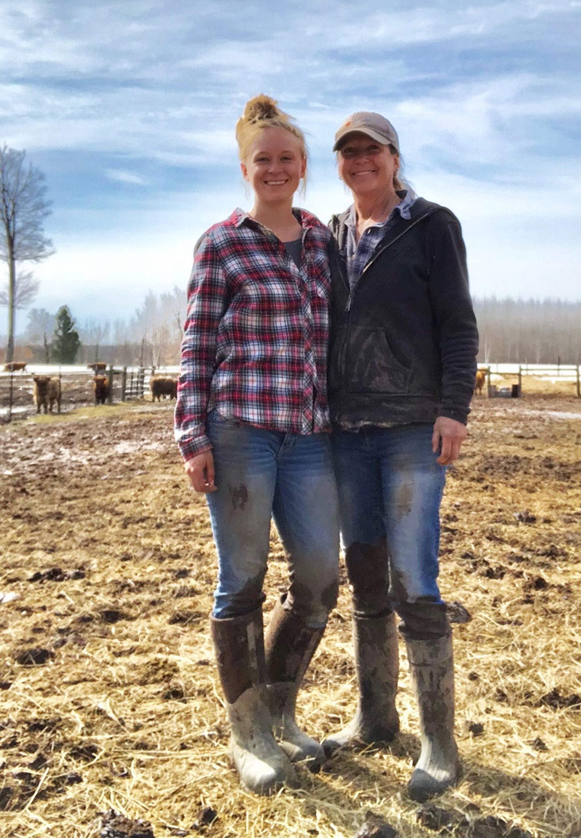 Young female cattle rancher, Molly Brown, standing beside her mom who works cattle with her