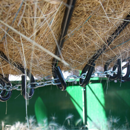 Hay bale in round bale feeder close up