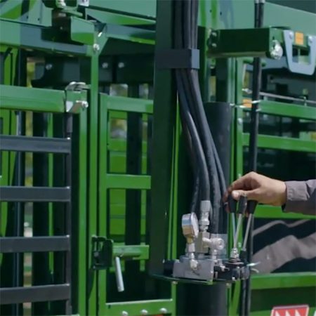 Hydraulic head sweep controls are mounted on the pivoting swing arm for ease of use