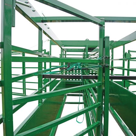 View down the portable corral system double alley with the locking swing gate closed creating a cattle-free zone