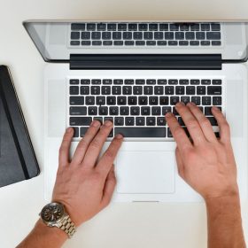 Farm equipment financing professional submitting application on laptop